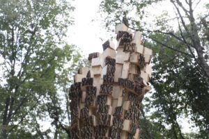 A tree cut into cubes standing outdoors.